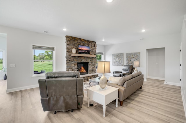 9867 Kahler Ave NE, Monticello, MN 55362 - living room with light wood finished floors, plenty of natural light, baseboards, a fireplace, and recessed lighting