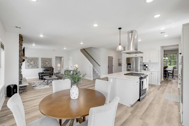 9867 Kahler Ave NE, Monticello, MN 55362 - dining area with stairs, light wood finished floors, recessed lighting, and baseboards