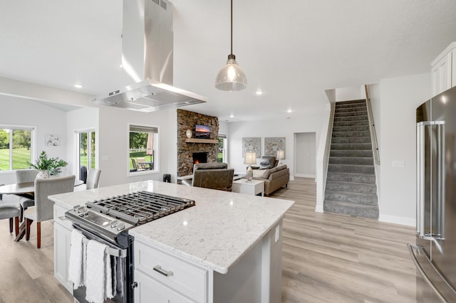 9867 Kahler Ave NE, Monticello, MN 55362 - kitchen featuring appliances with stainless steel finishes, island range hood, light wood-style floors, white cabinets, and recessed lighting