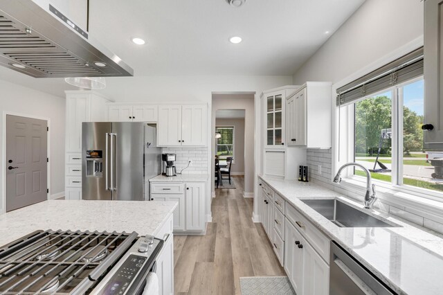 9867 Kahler Ave NE, Monticello, MN 55362 - kitchen featuring stainless steel appliances, under cabinet range hood, a sink, white cabinets, and recessed lighting