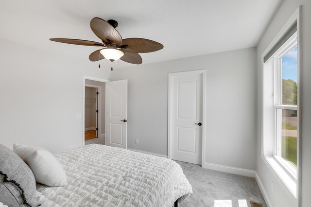 9867 Kahler Ave NE, Monticello, MN 55362 - bedroom featuring multiple windows, light colored carpet, baseboards, and a ceiling fan