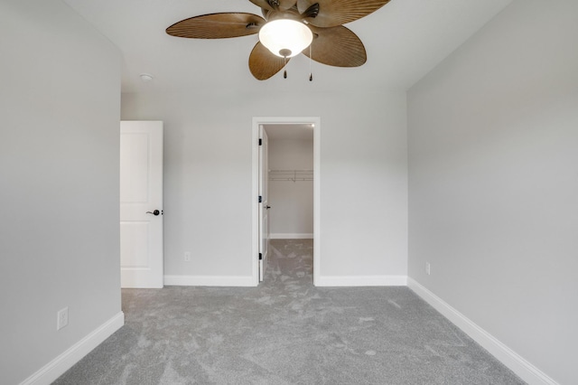 9867 Kahler Ave NE, Monticello, MN 55362 - unfurnished bedroom featuring carpet flooring, a walk in closet, ceiling fan, baseboards, and a closet