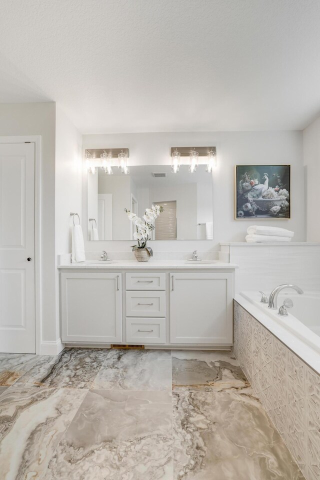 9867 Kahler Ave NE, Monticello, MN 55362 - full bathroom featuring marble finish floors, a garden tub, and double vanity