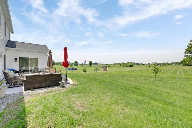 9867 Kahler Ave NE, Monticello, MN 55362 - view of green lawn with an outdoor living space, a patio, and a view of countryside