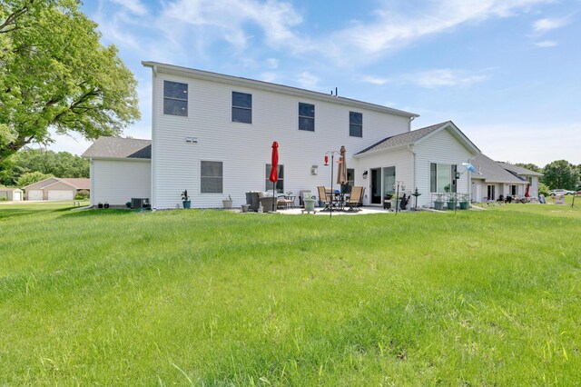 9867 Kahler Ave NE, Monticello, MN 55362 - back of property featuring a patio, a yard, and central air condition unit