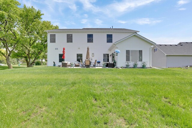9867 Kahler Ave NE, Monticello, MN 55362 - back of house featuring a patio area and a lawn