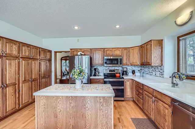 11760 88th Pl N, Maple Grove, MN 55369 - kitchen featuring appliances with stainless steel finishes, light wood-style floors, light countertops, a textured ceiling, and recessed lighting
