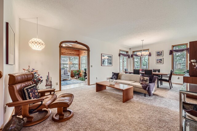 11760 88th Pl N, Maple Grove, MN 55369 - living room featuring a chandelier, carpet floors, and a textured ceiling