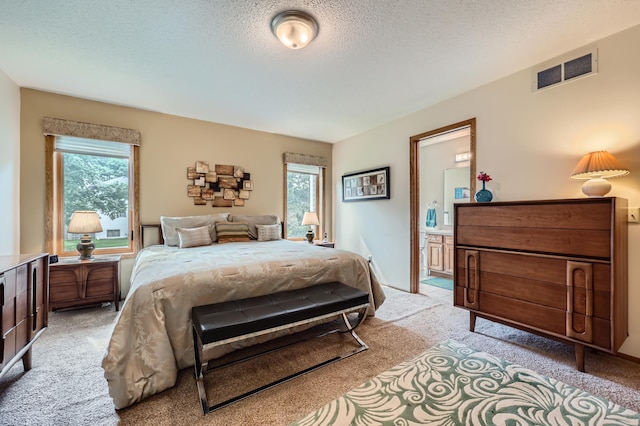 11760 88th Pl N, Maple Grove, MN 55369 - bedroom featuring light colored carpet, a textured ceiling, and ensuite bathroom