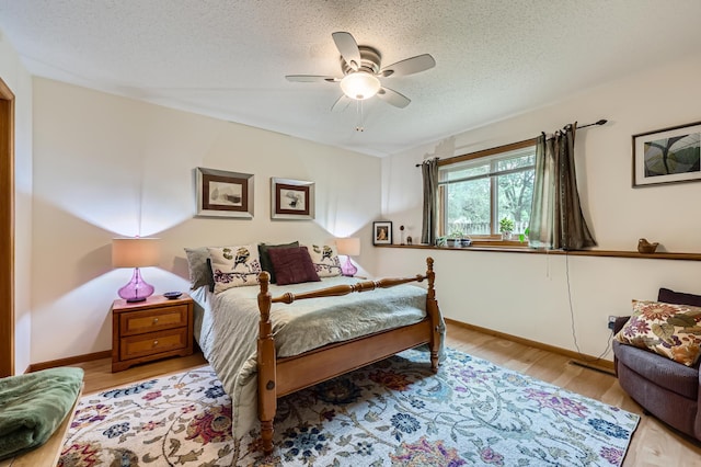 11760 88th Pl N, Maple Grove, MN 55369 - bedroom with wood finished floors, a textured ceiling, and ceiling fan