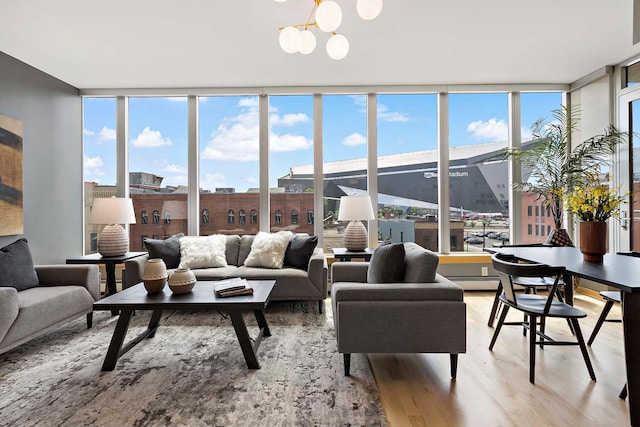 215 10th Ave S Unit 425, Minneapolis, MN 55415 - living room featuring a wall of windows, light wood-style flooring, healthy amount of natural light, and a chandelier