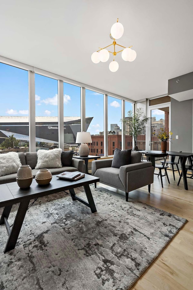 215 10th Ave S Unit 425, Minneapolis, MN 55415 - living area featuring a chandelier, wood finished floors, plenty of natural light, and floor to ceiling windows