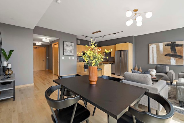 215 10th Ave S Unit 425, Minneapolis, MN 55415 - dining room with a chandelier, light wood-style floors, and rail lighting
