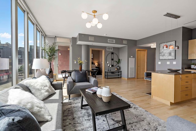 215 10th Ave S Unit 425, Minneapolis, MN 55415 - living area with expansive windows, light wood-style flooring, and a chandelier