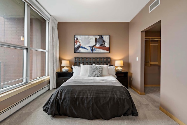 215 10th Ave S Unit 425, Minneapolis, MN 55415 - bedroom with a baseboard heating unit, carpet floors, a spacious closet, and a closet