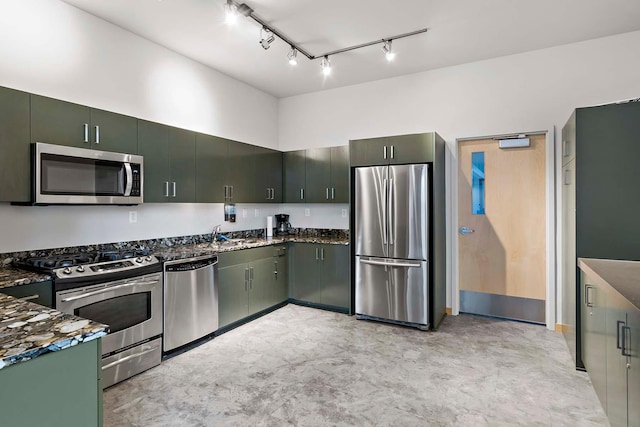 215 10th Ave S Unit 425, Minneapolis, MN 55415 - kitchen featuring stainless steel appliances, rail lighting, and dark stone countertops