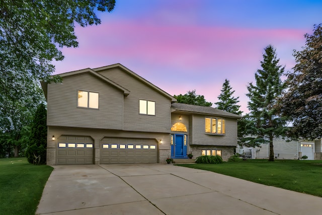 1201 Maplewood Dr, Delano, MN 55328 - view of front of property featuring an attached garage, a front yard, driveway, and brick siding