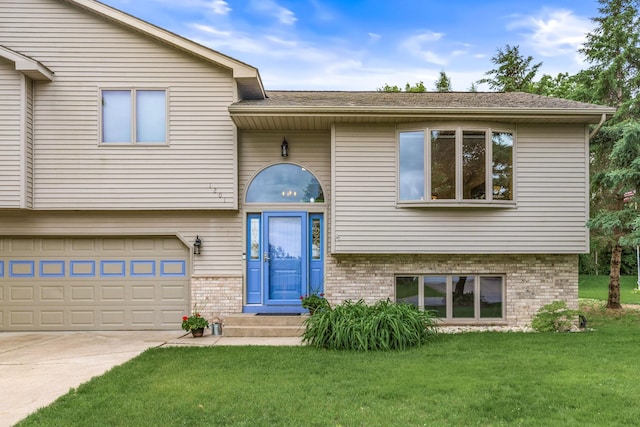 1201 Maplewood Dr, Delano, MN 55328 - view of front facade with brick siding, a front yard, driveway, an attached garage, and roof with shingles
