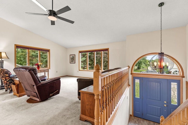 1201 Maplewood Dr, Delano, MN 55328 - carpeted living area with vaulted ceiling, a chandelier, a ceiling fan, and baseboards