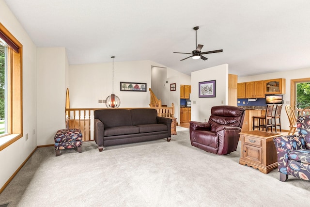 1201 Maplewood Dr, Delano, MN 55328 - living room with light carpet, baseboards, lofted ceiling, a ceiling fan, and a chandelier
