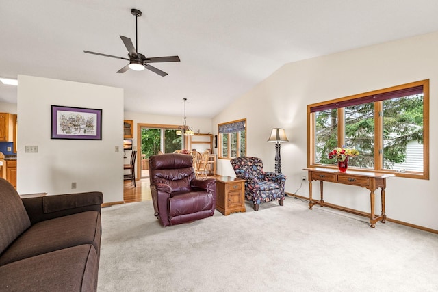 1201 Maplewood Dr, Delano, MN 55328 - living room featuring a ceiling fan, light colored carpet, baseboards, and vaulted ceiling
