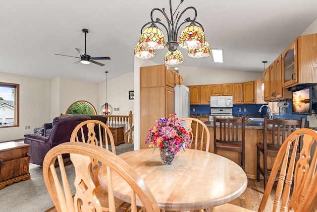 1201 Maplewood Dr, Delano, MN 55328 - dining space with lofted ceiling, ceiling fan, and a chandelier
