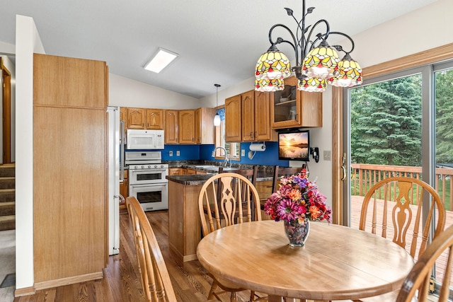 1201 Maplewood Dr, Delano, MN 55328 - dining area with vaulted ceiling, dark wood-style floors, stairway, and a chandelier