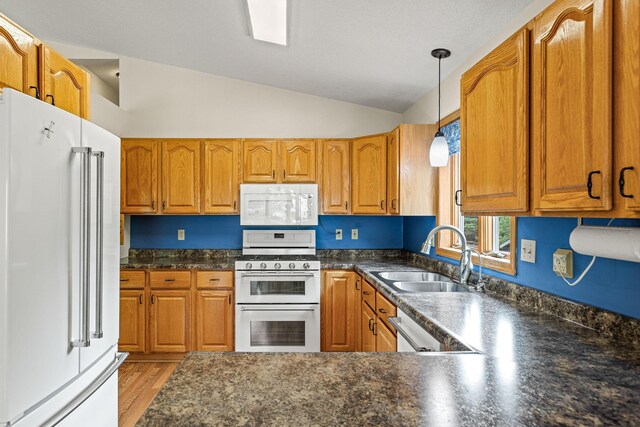 1201 Maplewood Dr, Delano, MN 55328 - kitchen with white appliances, a sink, brown cabinetry, dark countertops, and lofted ceiling
