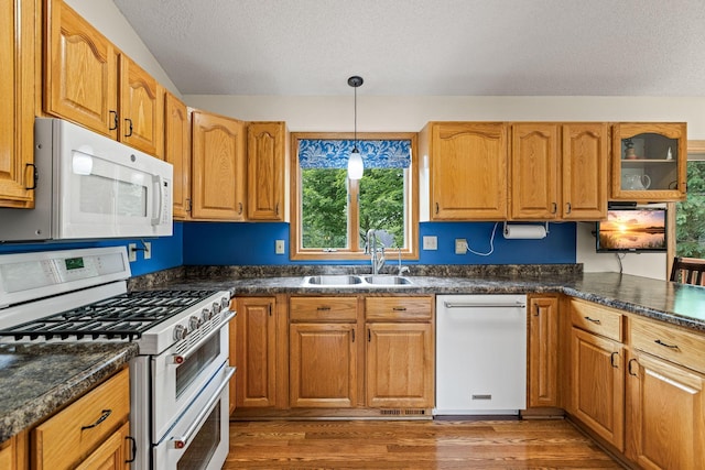 1201 Maplewood Dr, Delano, MN 55328 - kitchen featuring white appliances, a sink, a textured ceiling, wood finished floors, and decorative light fixtures