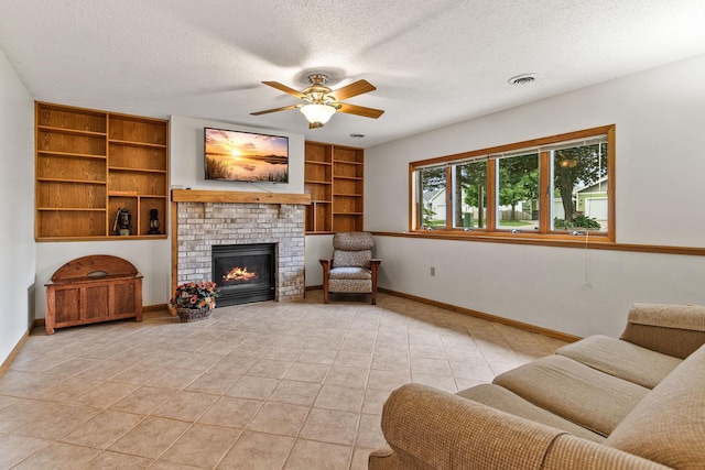 1201 Maplewood Dr, Delano, MN 55328 - living area featuring ceiling fan, built in features, baseboards, a textured ceiling, and light tile patterned floors