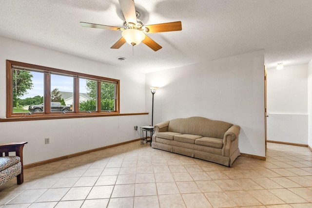 1201 Maplewood Dr, Delano, MN 55328 - sitting room featuring ceiling fan, a textured ceiling, baseboards, and light tile patterned floors
