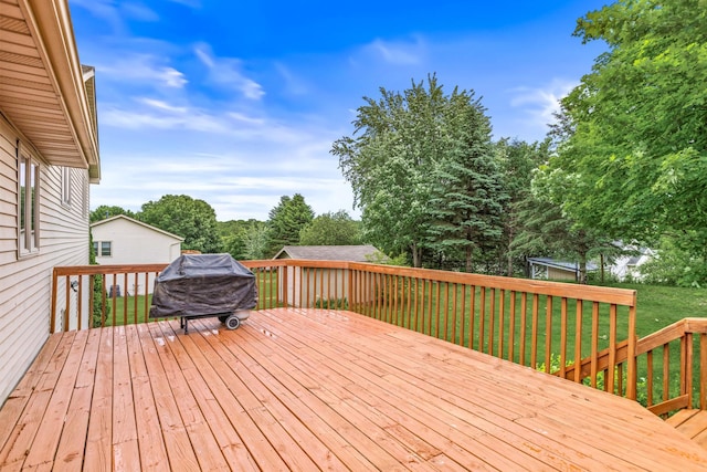1201 Maplewood Dr, Delano, MN 55328 - wooden deck with area for grilling and a lawn