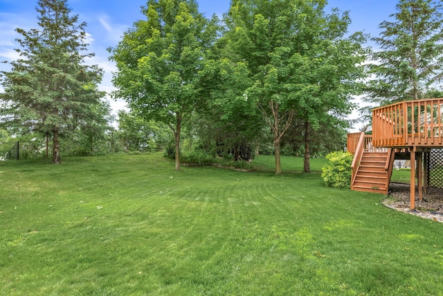 1201 Maplewood Dr, Delano, MN 55328 - view of grassy yard featuring stairs and a deck