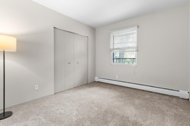 666 Ashland Ave Unit 5, Saint Paul, MN 55104 - unfurnished bedroom with a baseboard radiator, carpet flooring, and a closet