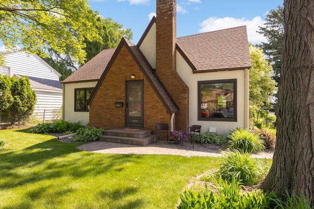 4313 Arthur St NE, Columbia Heights, MN 55421 - rear view of property featuring a chimney, stucco siding, and roof with shingles