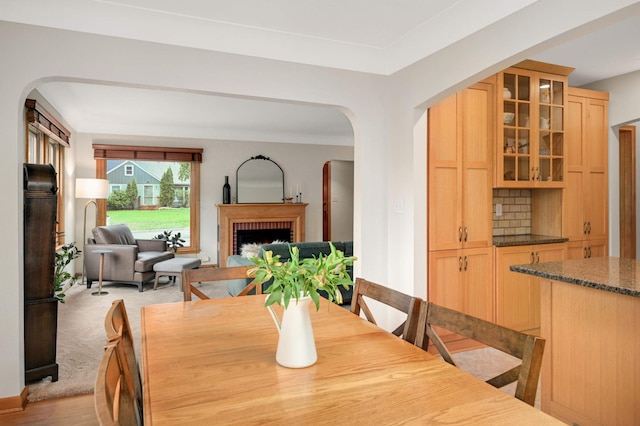 4313 Arthur St NE, Columbia Heights, MN 55421 - dining room featuring arched walkways, a fireplace, and light wood-style flooring
