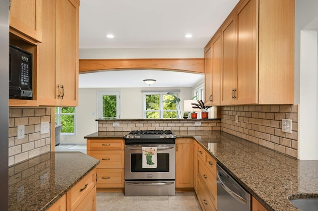 4313 Arthur St NE, Columbia Heights, MN 55421 - kitchen featuring stainless steel appliances, plenty of natural light, tasteful backsplash, dark stone counters, and recessed lighting