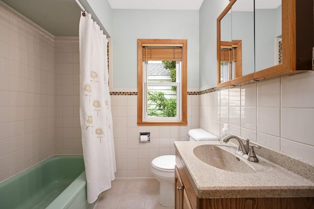 4313 Arthur St NE, Columbia Heights, MN 55421 - bathroom with tile walls, tile patterned flooring, vanity, toilet, and shower / tub combo