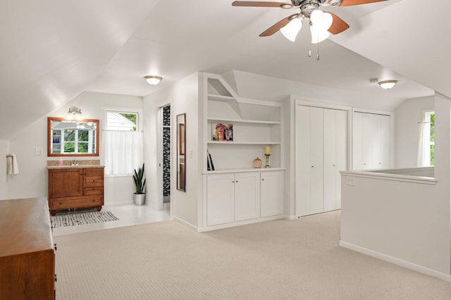 4313 Arthur St NE, Columbia Heights, MN 55421 - additional living space with lofted ceiling, ceiling fan, healthy amount of natural light, baseboards, and light colored carpet