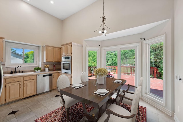 13914 Duluth Dr, Apple Valley, MN 55124 - kitchen with appliances with stainless steel finishes, light brown cabinets, light tile patterned floors, healthy amount of natural light, and a towering ceiling