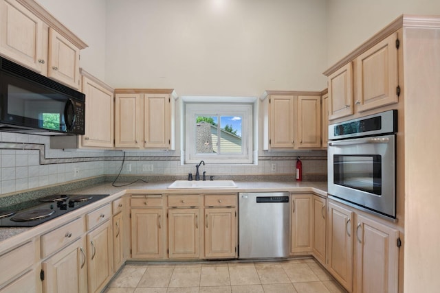 13914 Duluth Dr, Apple Valley, MN 55124 - kitchen with black appliances, light brown cabinets, a high ceiling, and backsplash