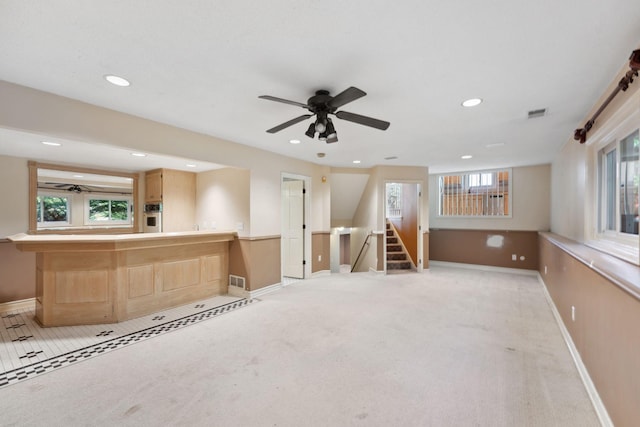 13914 Duluth Dr, Apple Valley, MN 55124 - unfurnished living room featuring light carpet, ceiling fan, recessed lighting, stairway, and bar area