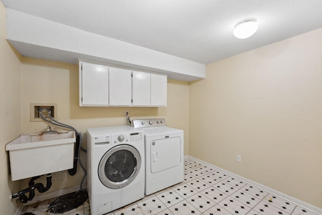 13914 Duluth Dr, Apple Valley, MN 55124 - washroom featuring separate washer and dryer, cabinet space, and a textured ceiling