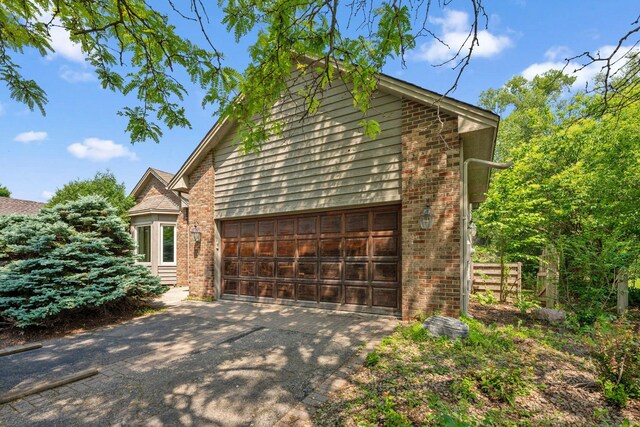 13914 Duluth Dr, Apple Valley, MN 55124 - view of side of home featuring brick siding and driveway