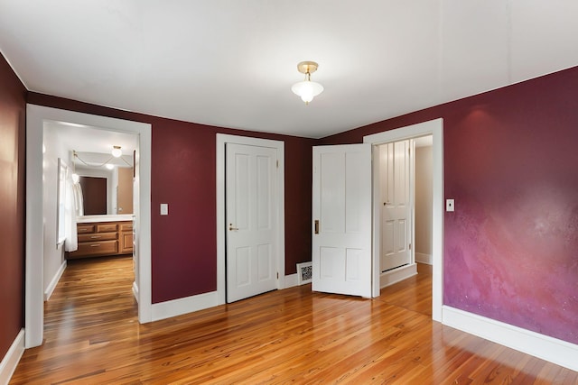 1206 2nd St W, Hastings, MN 55033 - unfurnished bedroom with light wood-style floors, baseboards, and a closet