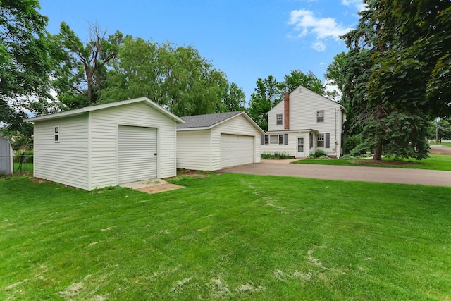 1206 2nd St W, Hastings, MN 55033 - view of front of property with a garage, an outdoor structure, and a front lawn