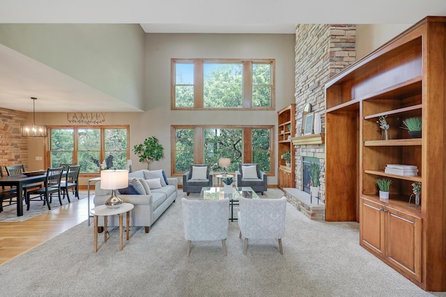 904 Ridgecrest Dr, Carver, MN 55315 - living area with a brick fireplace, a towering ceiling, built in features, and a chandelier
