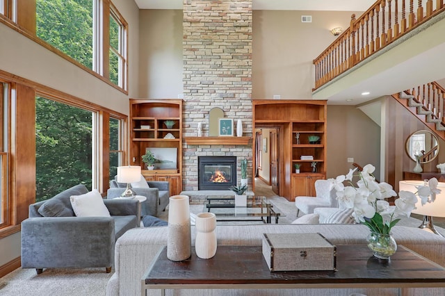 904 Ridgecrest Dr, Carver, MN 55315 - living area with a high ceiling, a fireplace, stairs, and carpet flooring