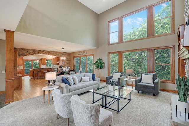 904 Ridgecrest Dr, Carver, MN 55315 - living area with a high ceiling, light wood-style flooring, a chandelier, and arched walkways