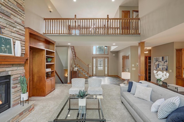 904 Ridgecrest Dr, Carver, MN 55315 - living room with a high ceiling, a stone fireplace, stairway, carpet, and recessed lighting